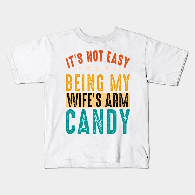 It's Not Easy Being My Wife's Arm Candy But Here I Am Nailing Kids T-Shirt by Design Voyage